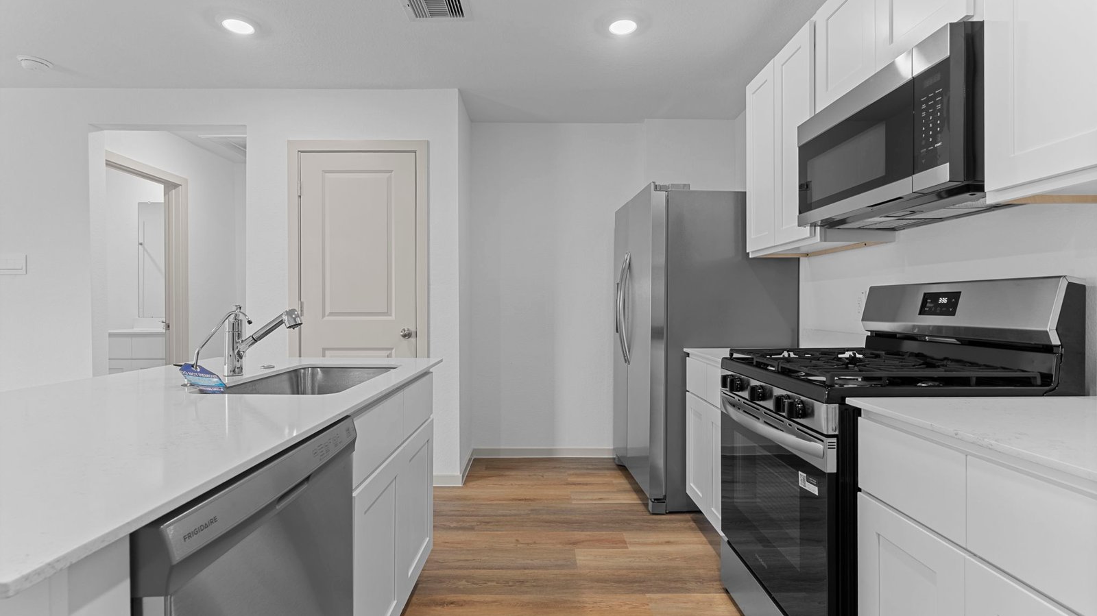 open concept kitchen with island and walk in pantry