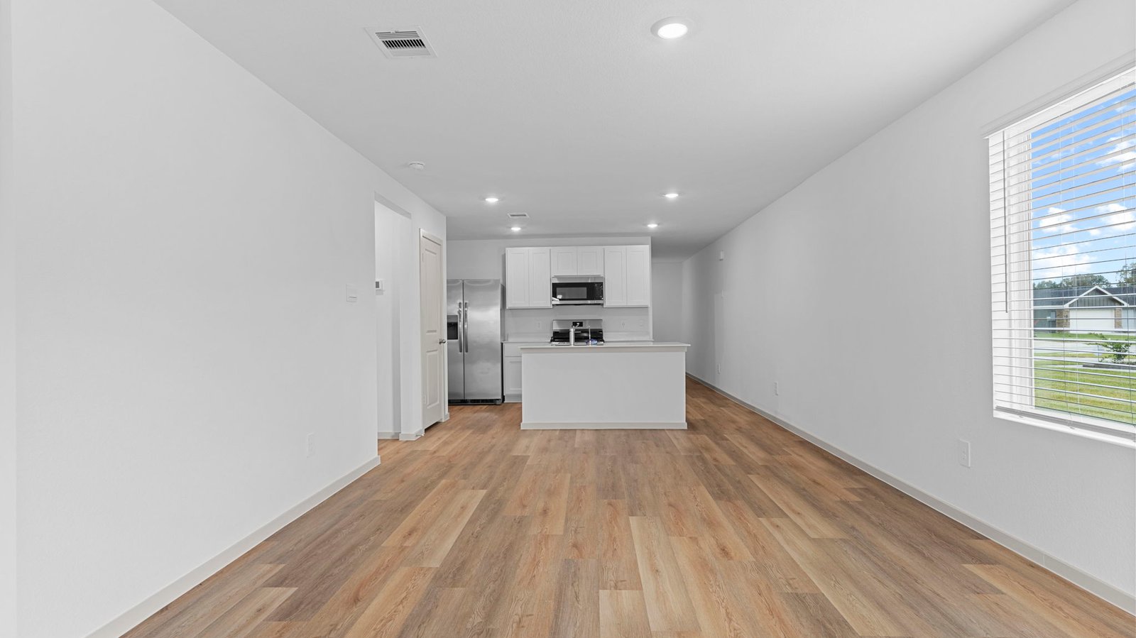 open concept kitchen, dining, and living room