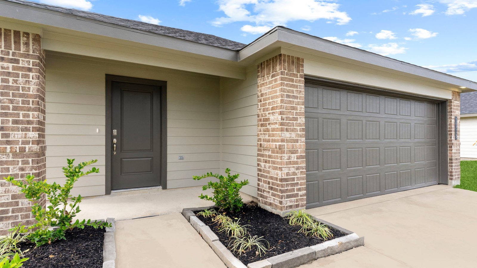 single story brick home with a two car garage