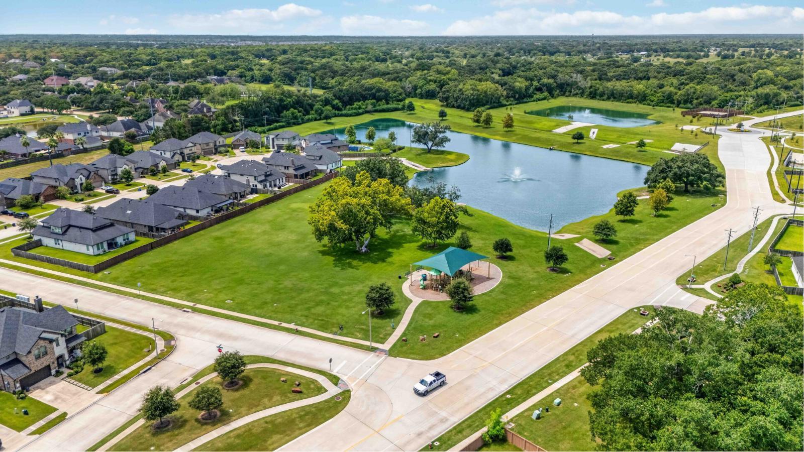 friendswood trails aerial view of the community with a pond and walking trails
