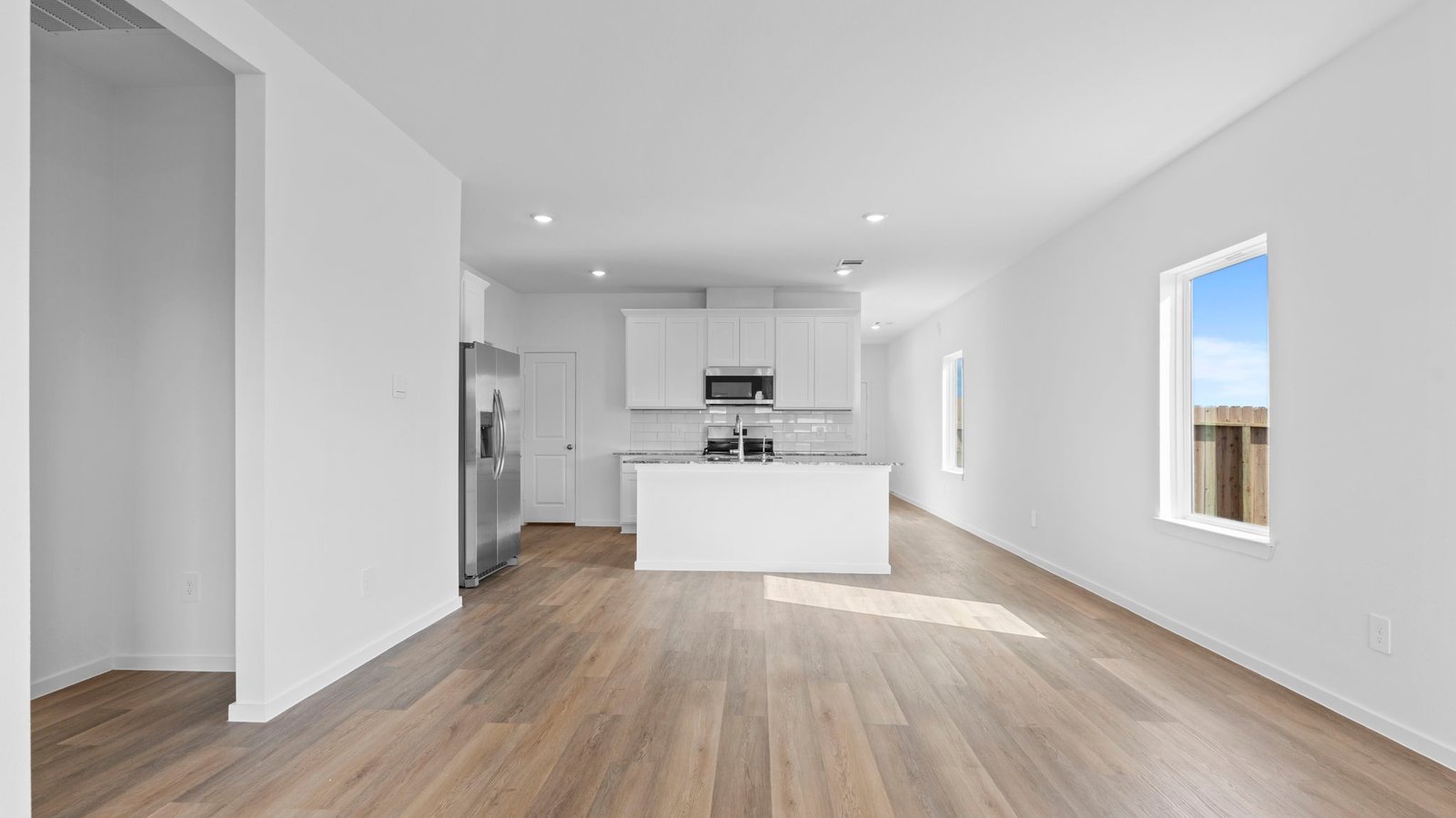 open concept dining room and living room with multiple windows