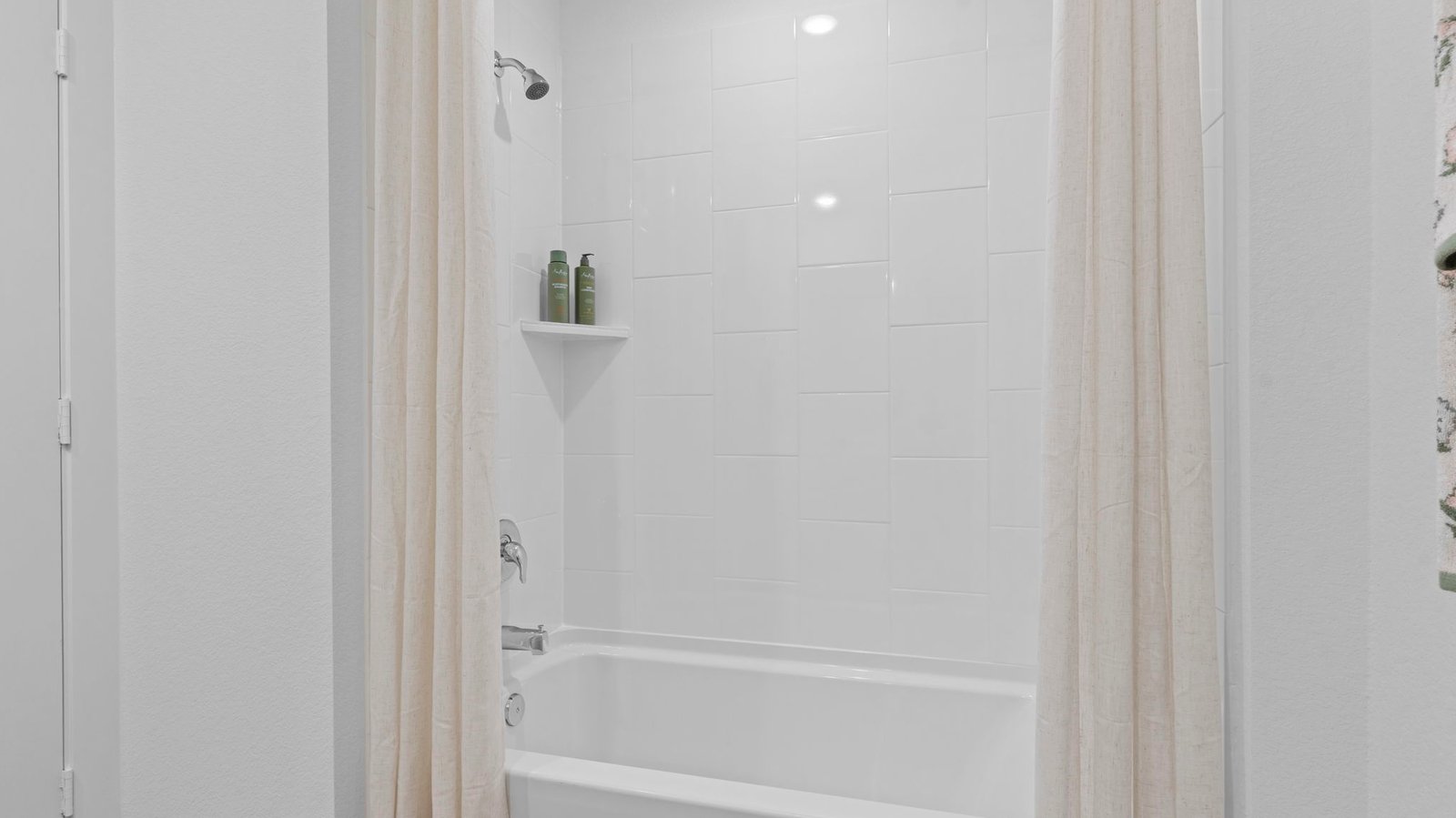 secondary bathroom with bathtub and shower combo