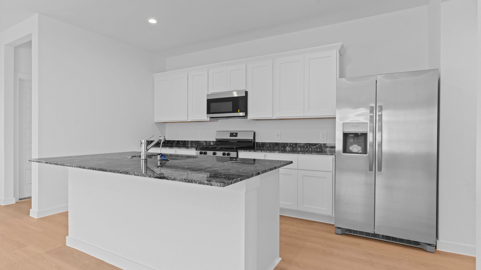 kitchen with white cabinetry, large island, and stainless steel appliances