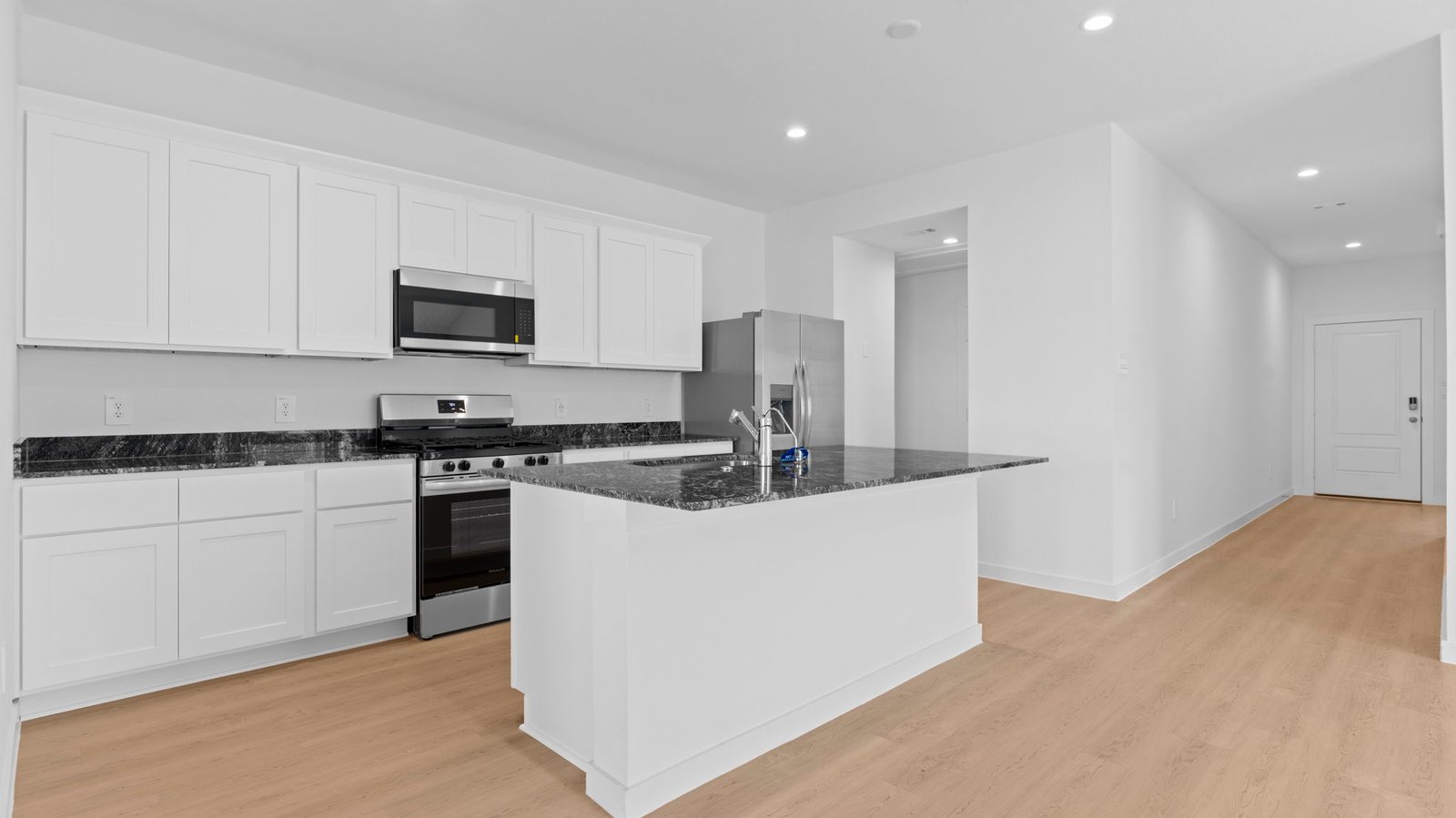 kitchen with white cabinetry, large island, and stainless steel appliances