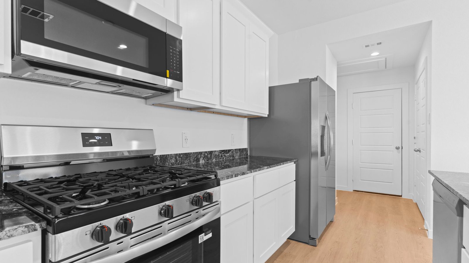 kitchen with white cabinetry, large island, and stainless steel appliances