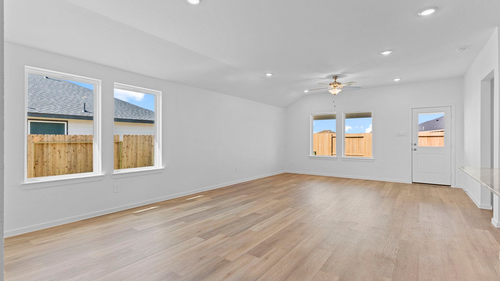 open concept dining and living room with  multiple windows