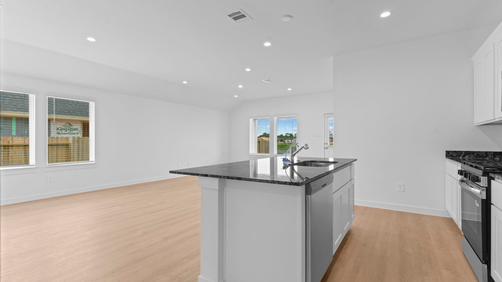 Open concept first floor with the living room, dining room and kitchen next to each other