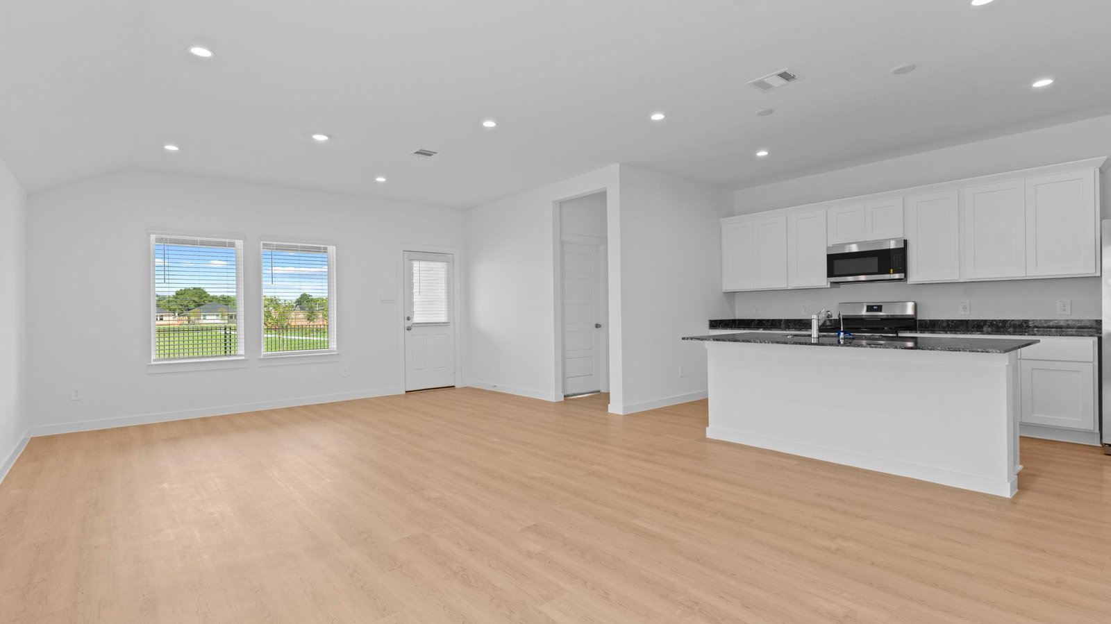 Open concept first floor with the living room, dining room and kitchen next to each other