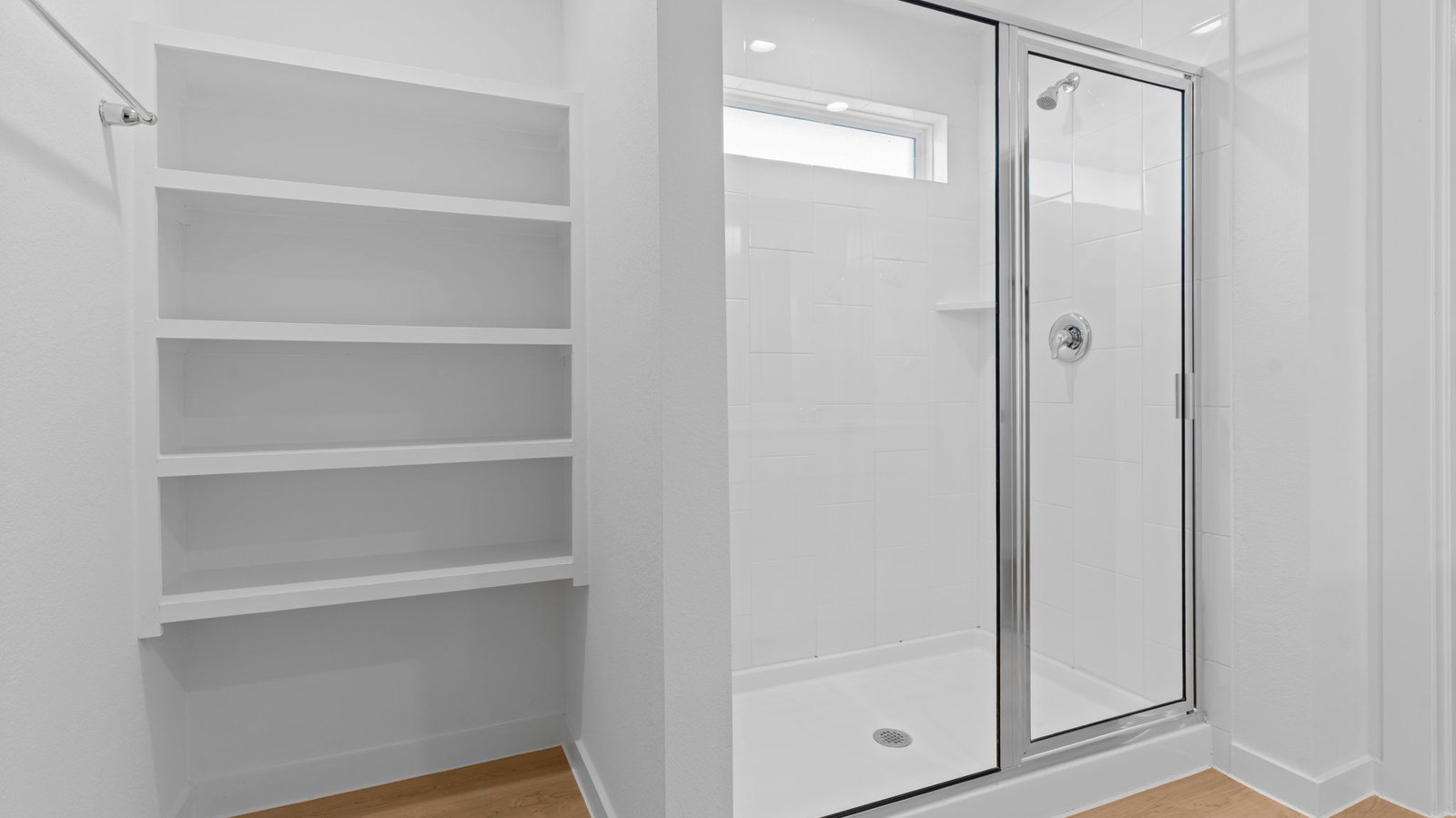 bathroom with dual vanity sinks, toilet, and a walk in shower