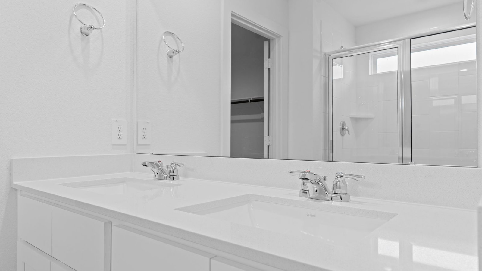 bathroom with dual vanity sinks, toilet, and a walk in shower