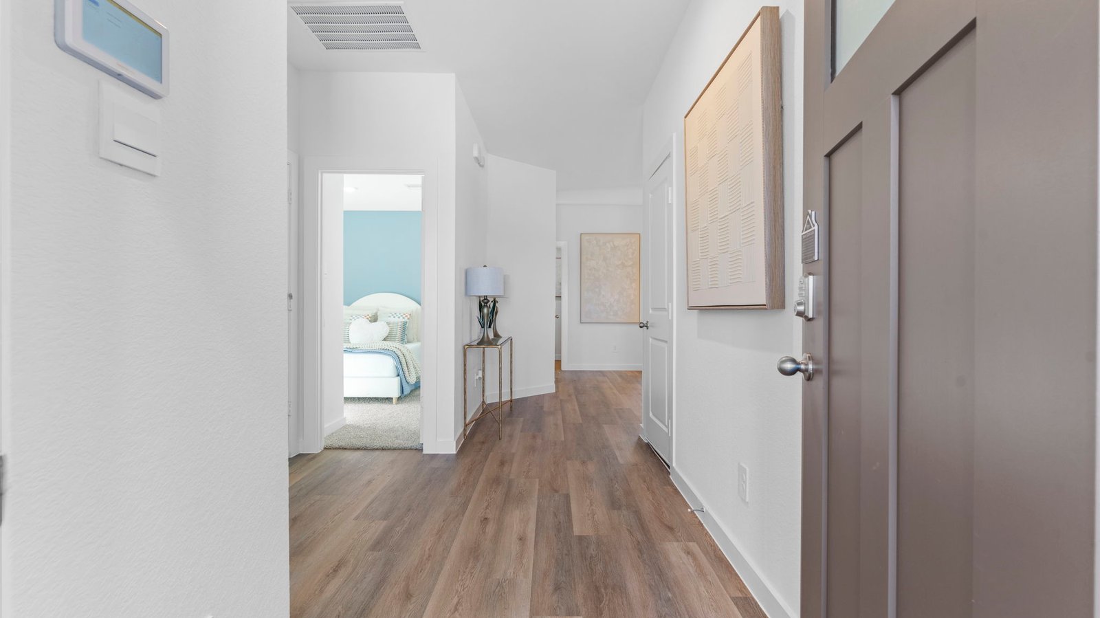 Entry hallway leading to living room and kitchen in the background.