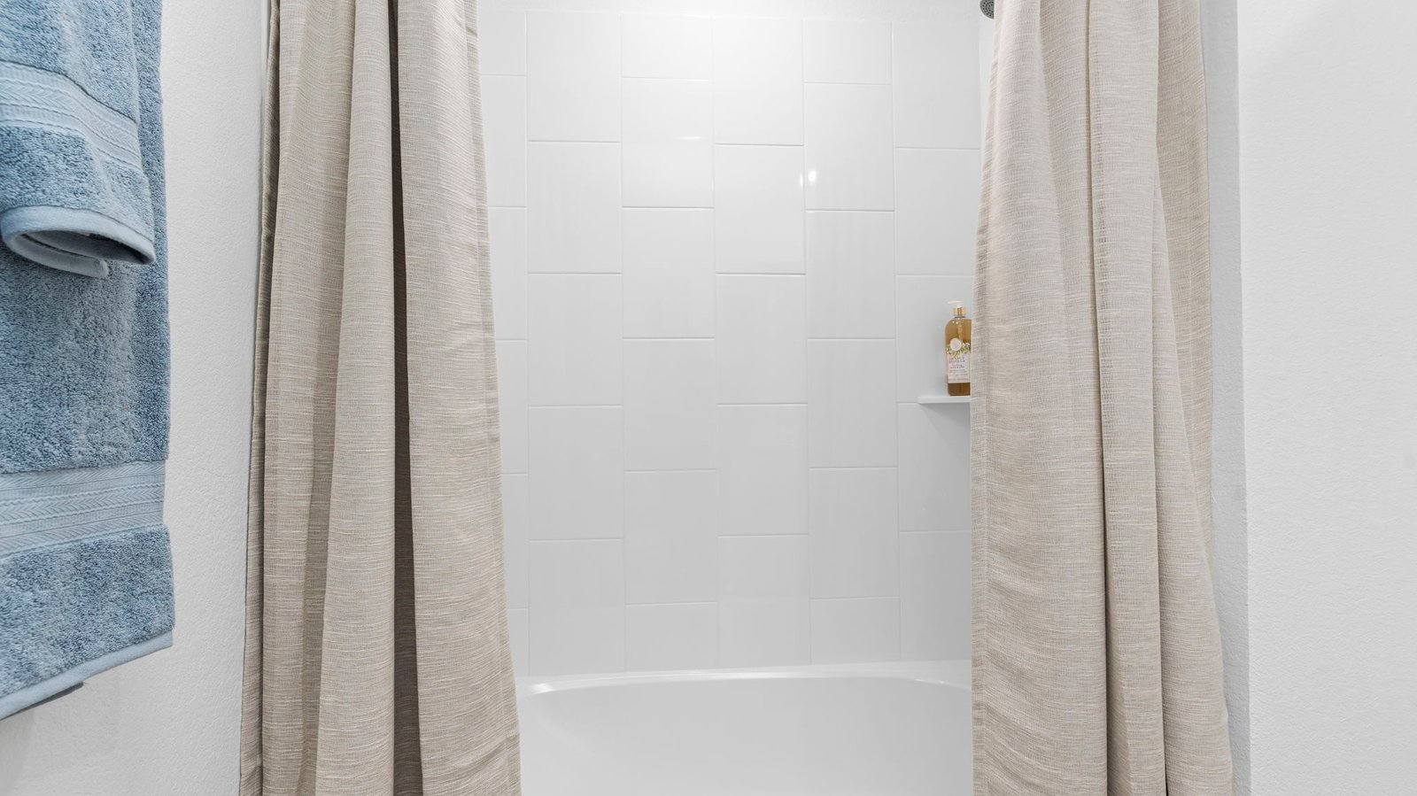 A well-designed bathroom equipped with granite countertops, a standing tub, and a single vanity.
