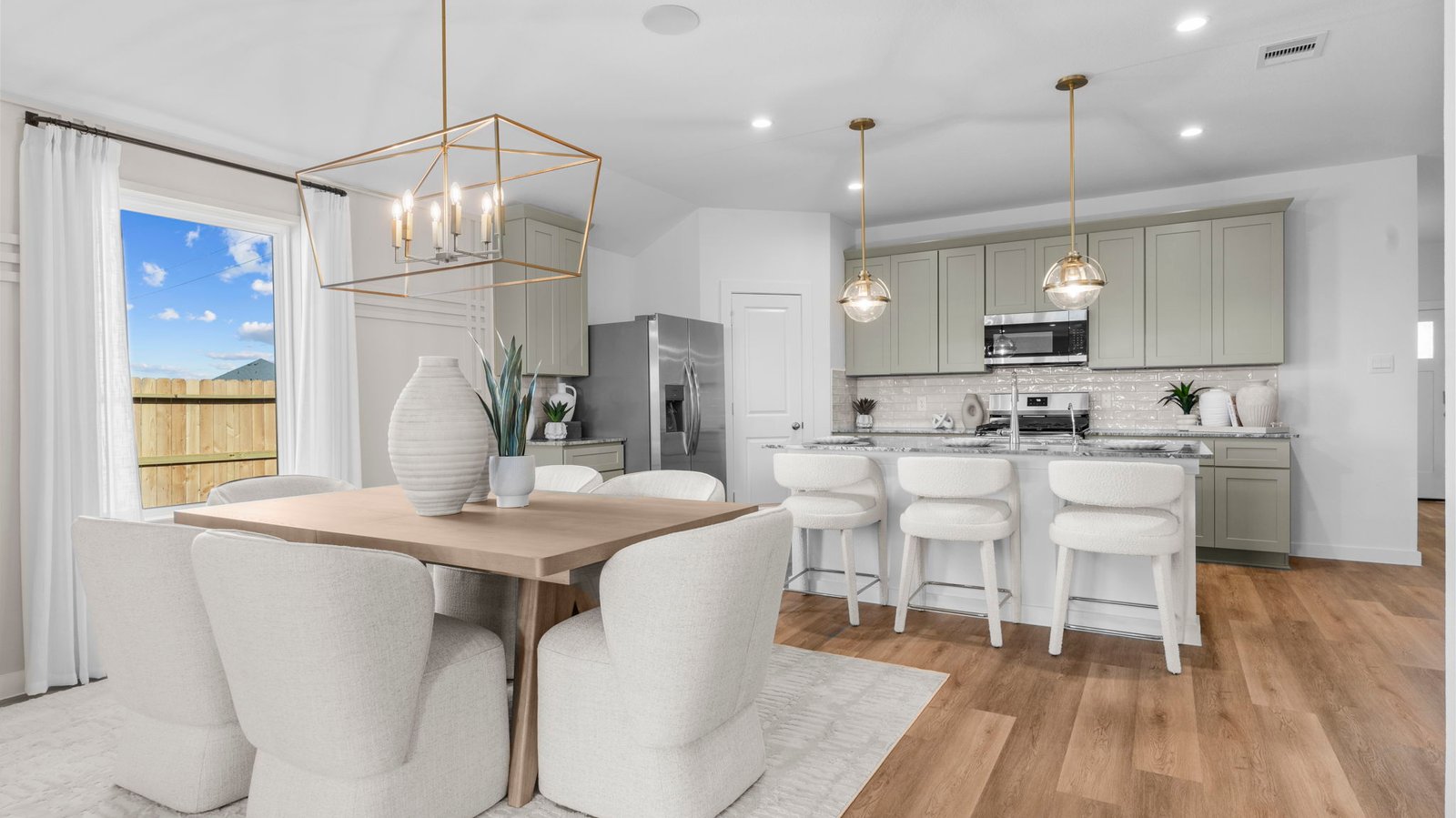 Spacious open concept dining area with vinyl wood flooring and access to the living and kitchen areas