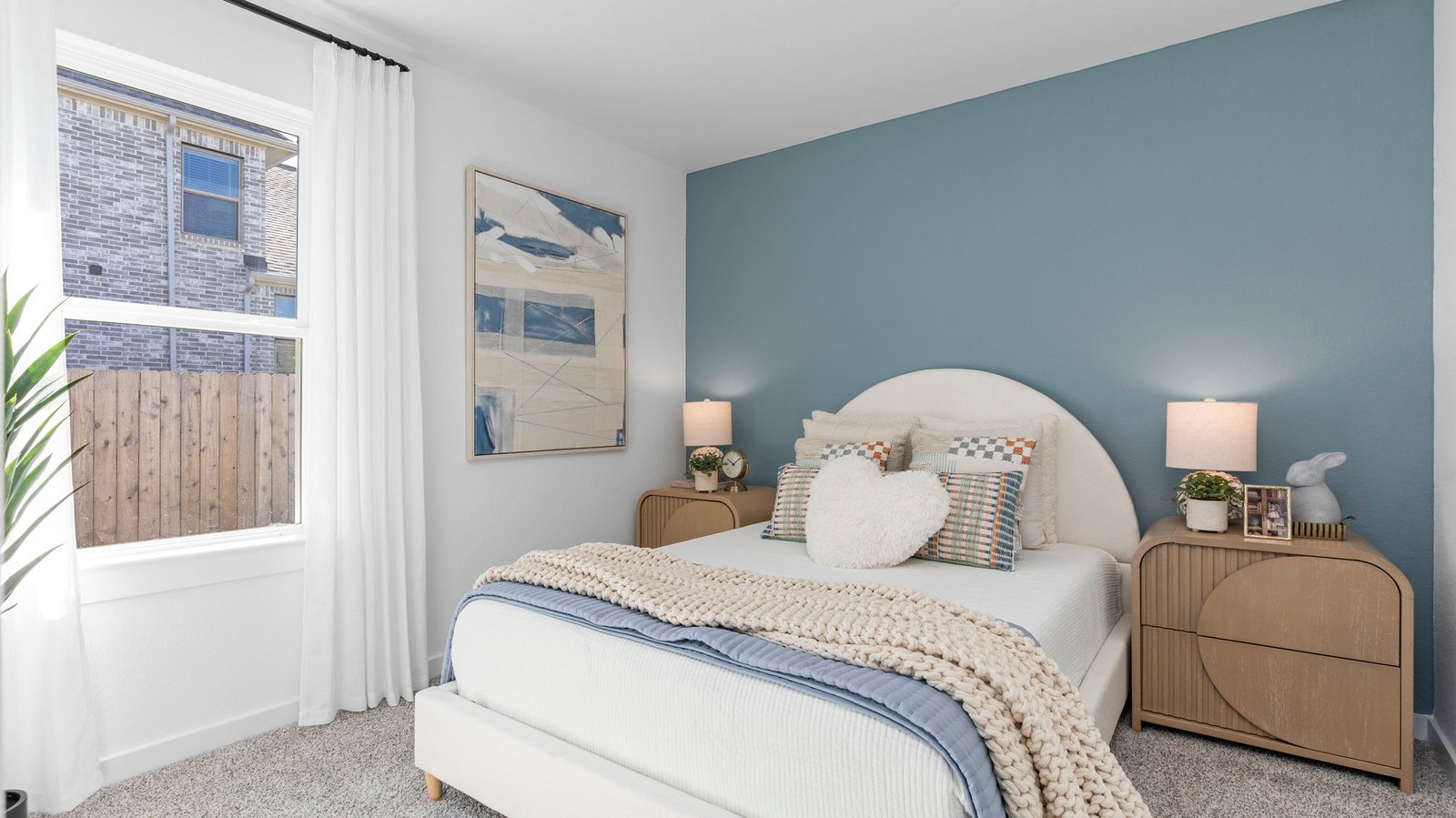 Comfortable guest bedroom featuring neutral-toned walls, carpeted flooring, and a separate closet.