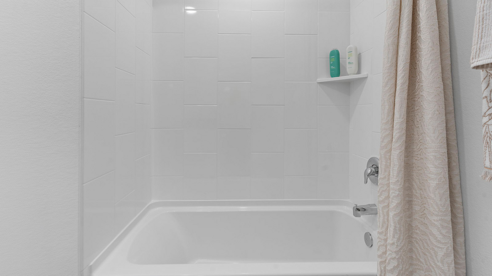 secondary bathroom with bathtub and shower combo