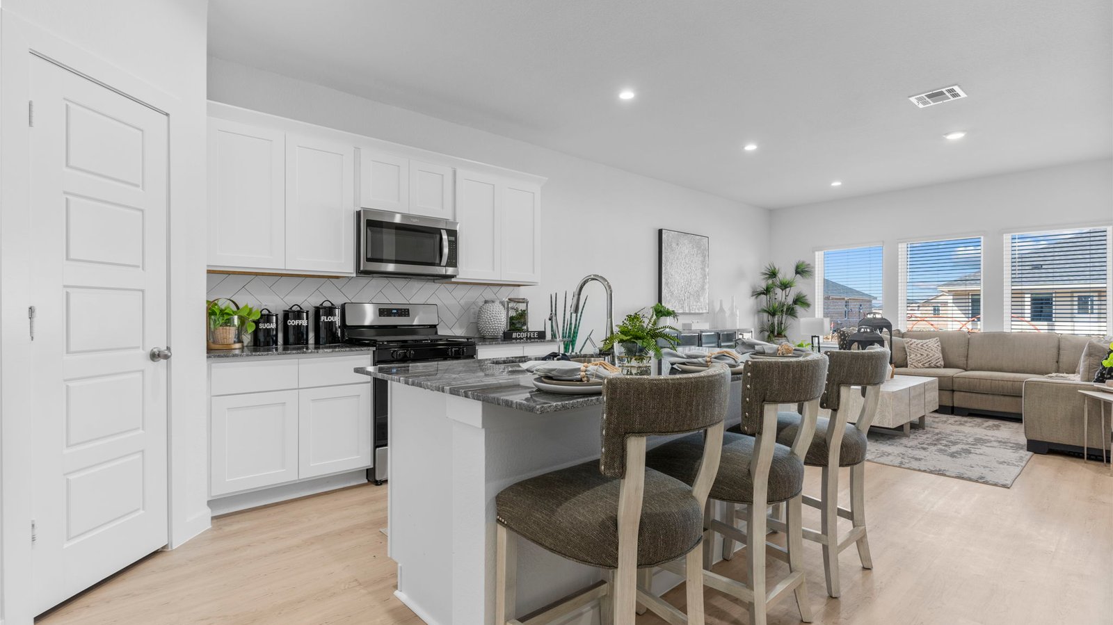 open concept kitchen with island and walk in pantry