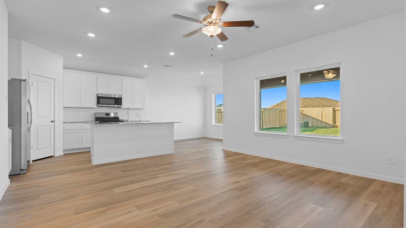 open concept kitchen and living room with large window