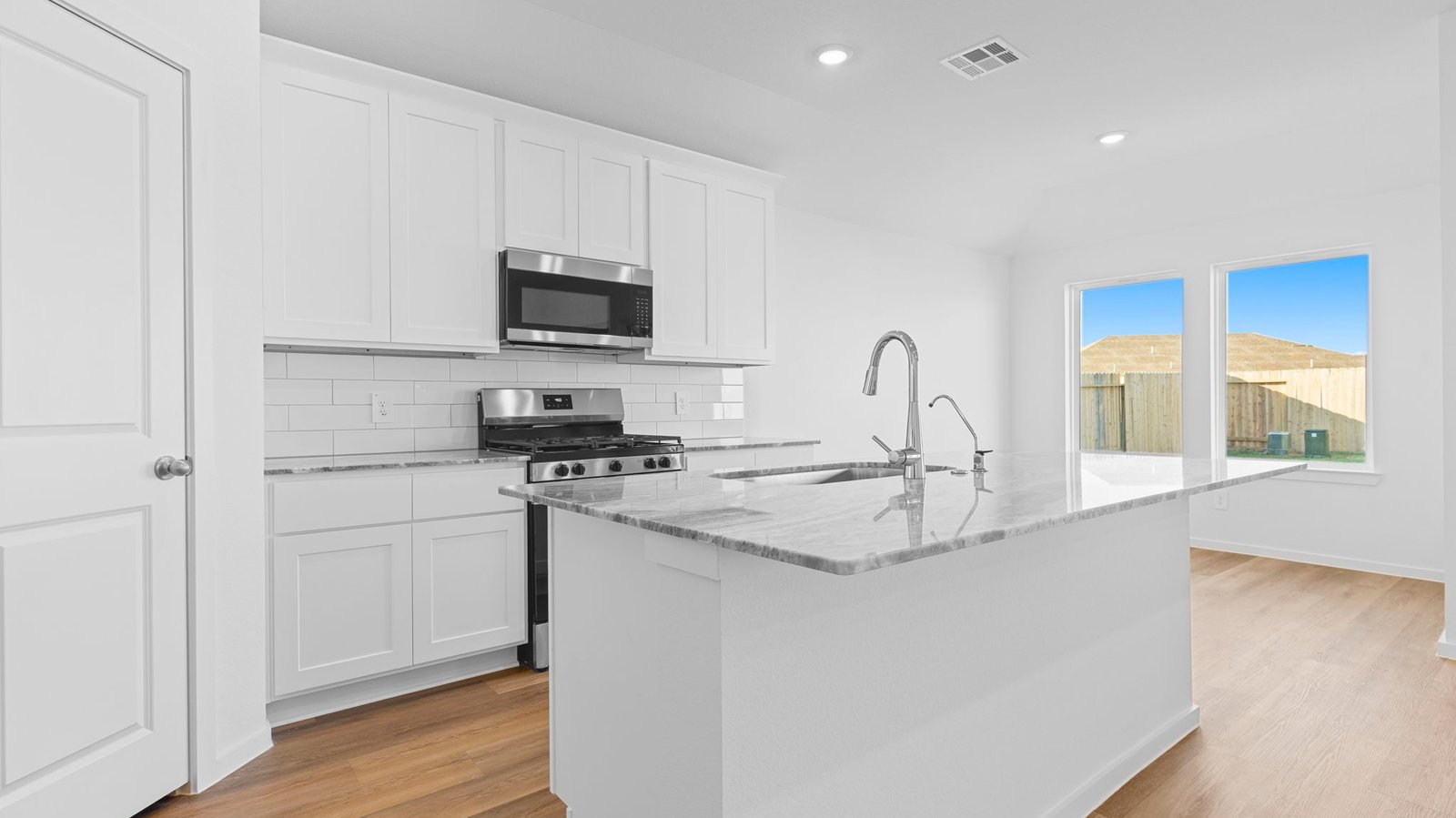 Spacious open concept kitchen with island and counter prep space