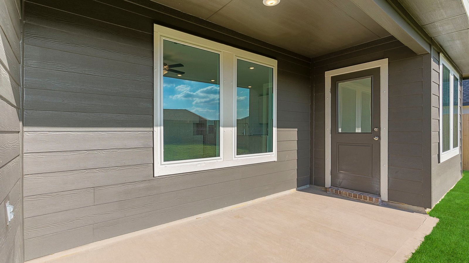 covered back patio overlooking spacious backyard