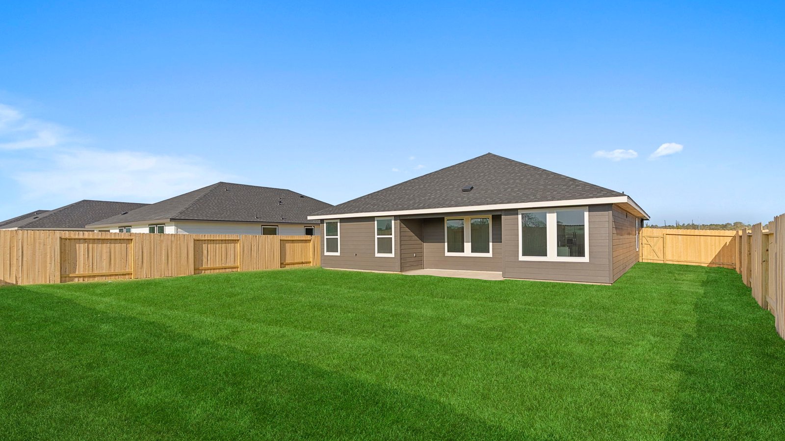 covered back patio overlooking spacious backyard