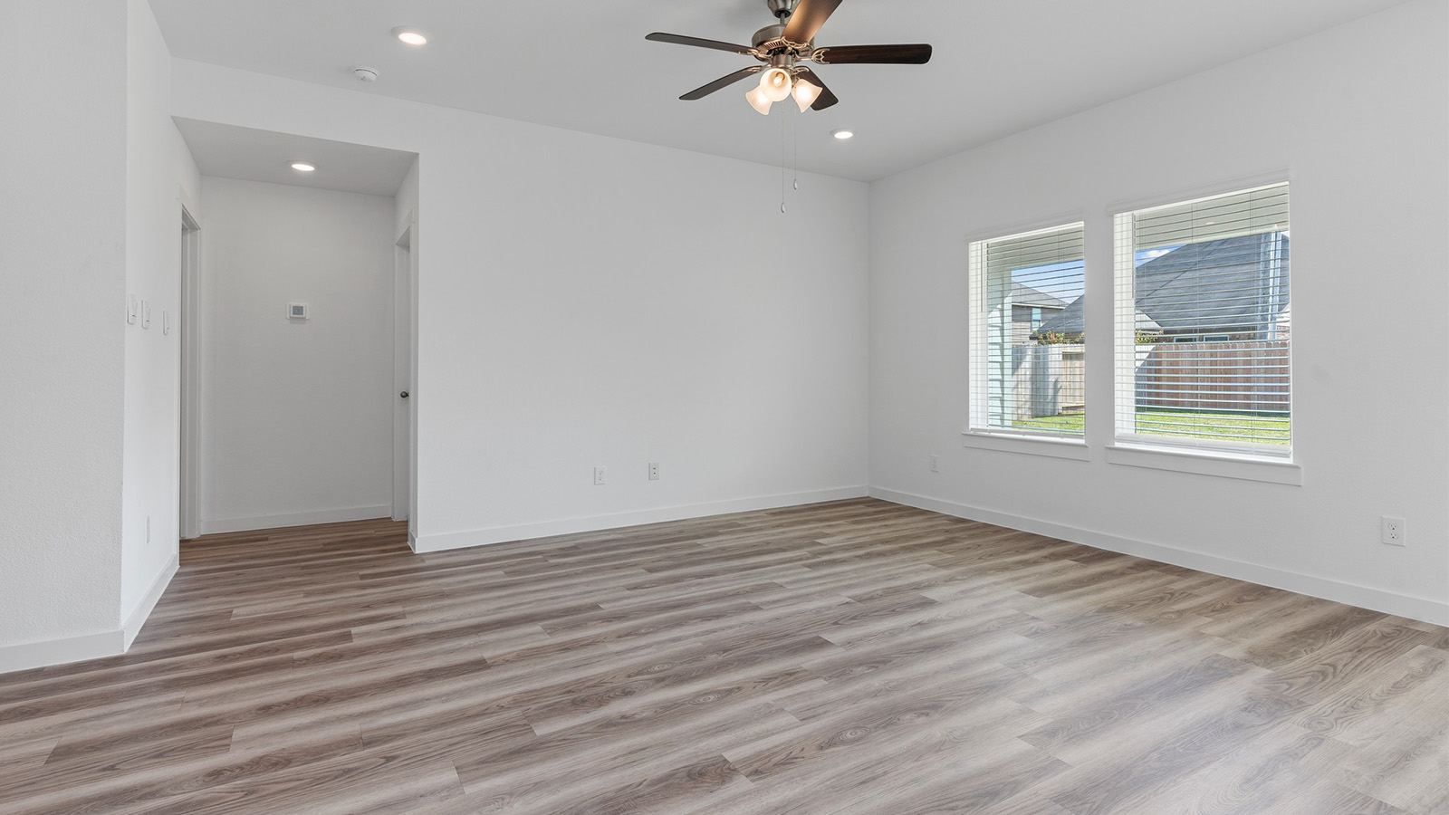 Living room with two large windows and celling fan