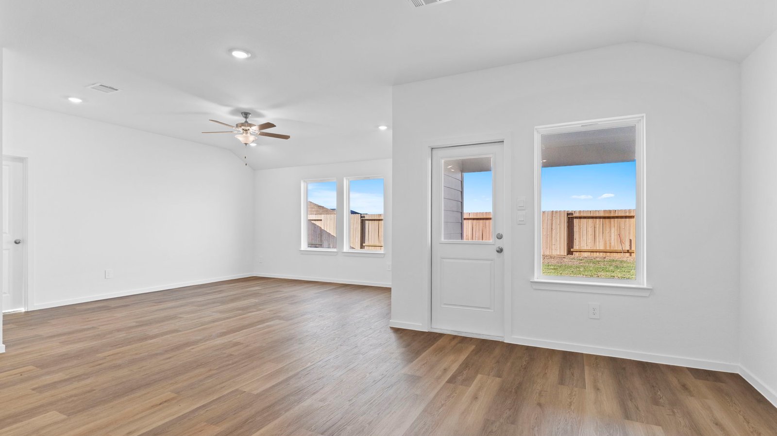 open concept living room and dining room with mulitple window