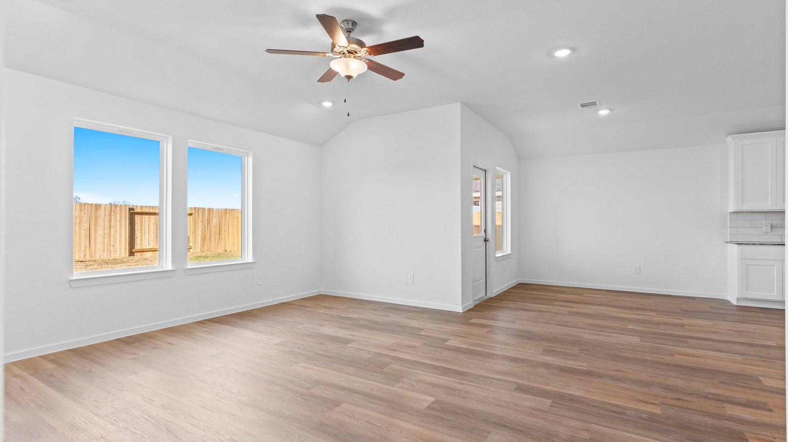 open concept living room and dining room with multiple window