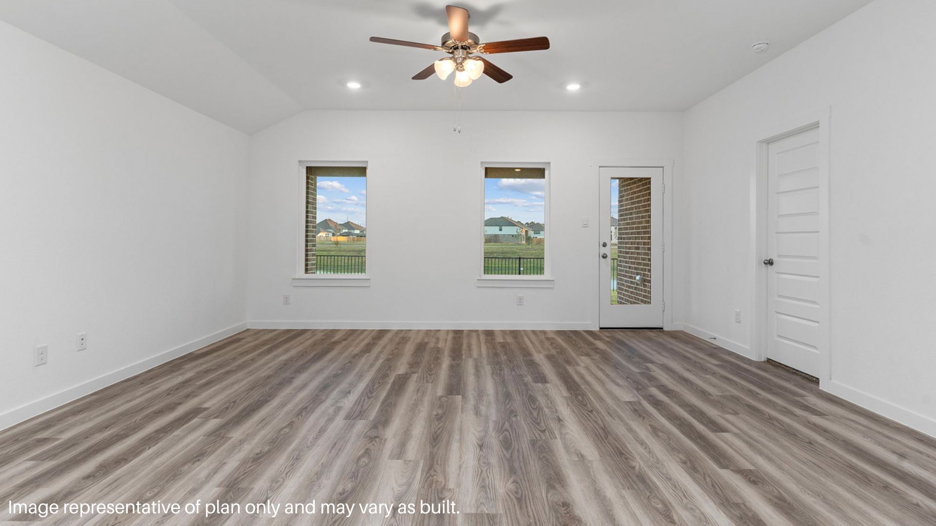 Spacious family room with vinyl flooring and bright windows.