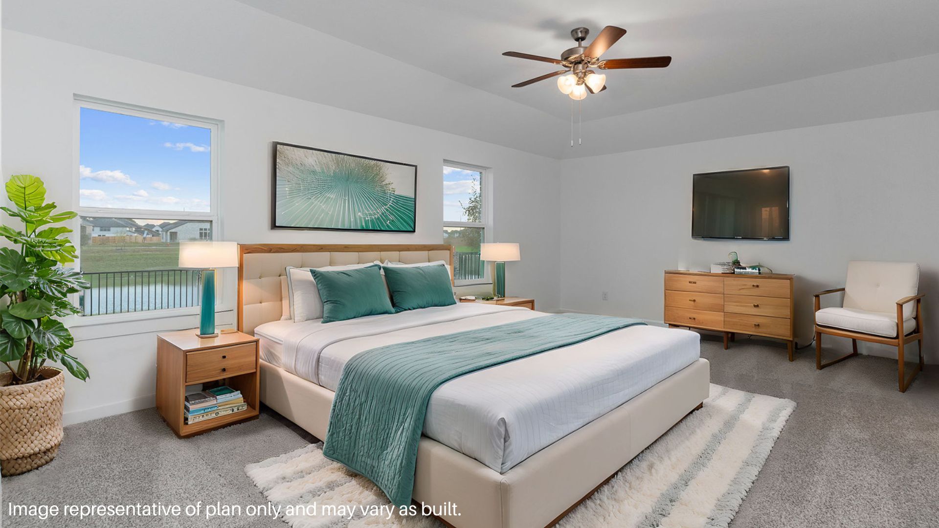 Spacious primary bedroom with carpet flooring and two bright windows.