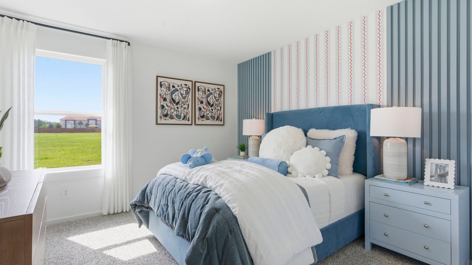 Comfortable guest bedroom featuring neutral-toned walls, carpeted flooring, and a separate closet.