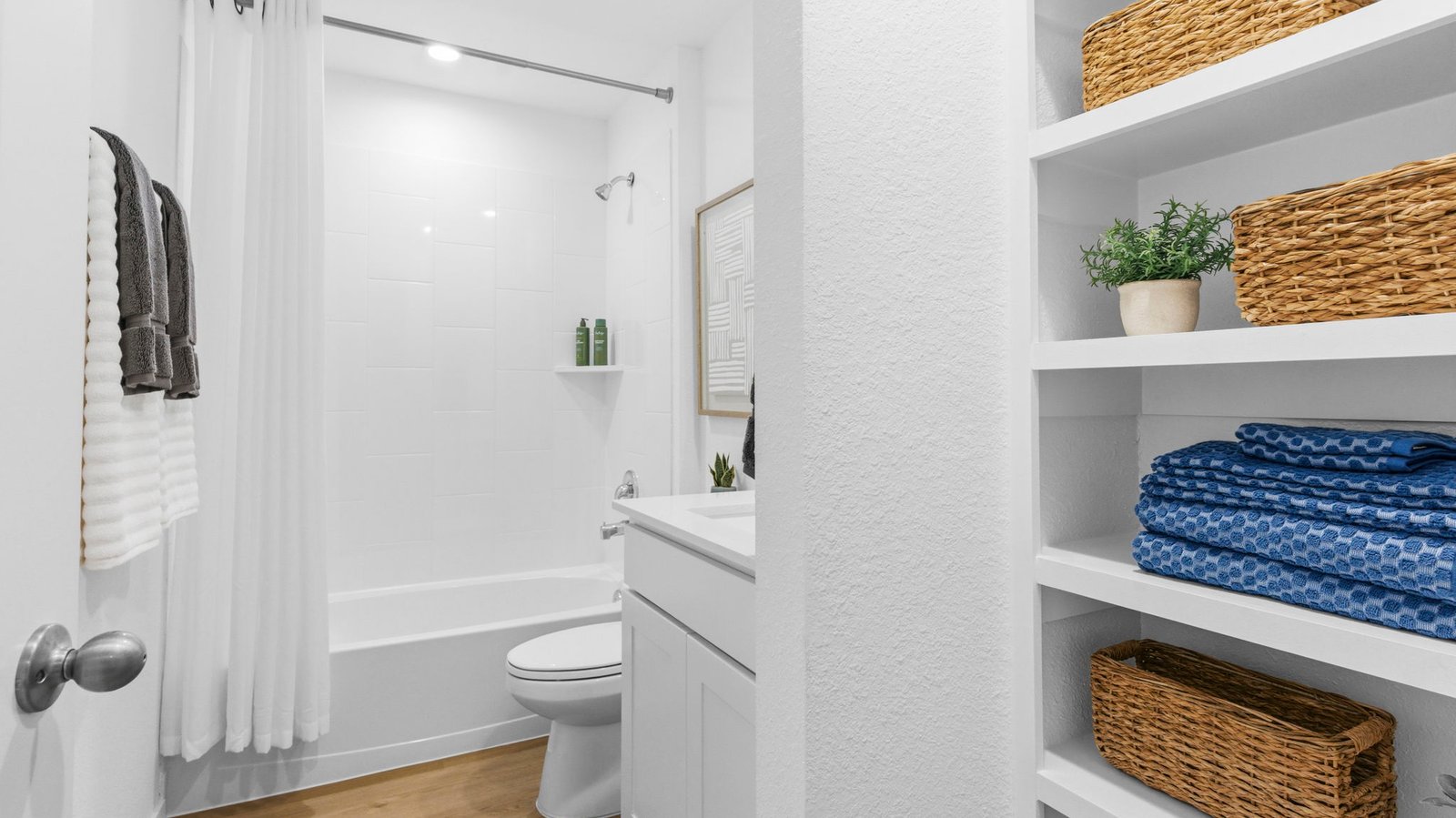 A well-designed bathroom equipped with quartz countertops, a standing tub, and a single vanity.