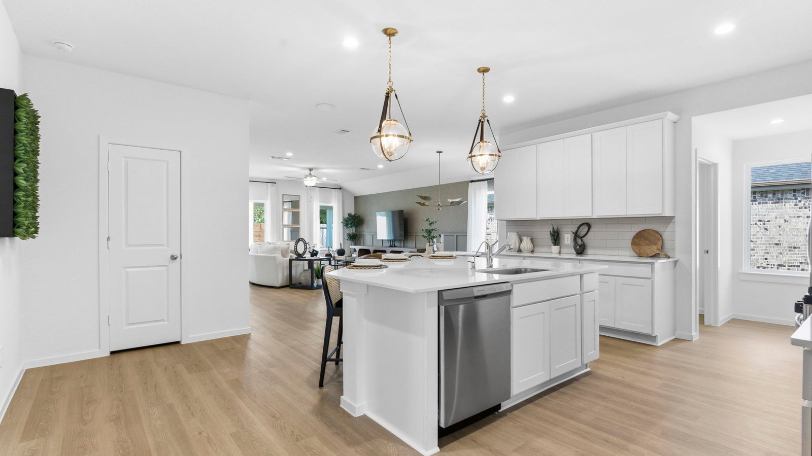 Bright and spacious kitchen with granite countertops, stainless steel appliances, and an island with bar seating.
