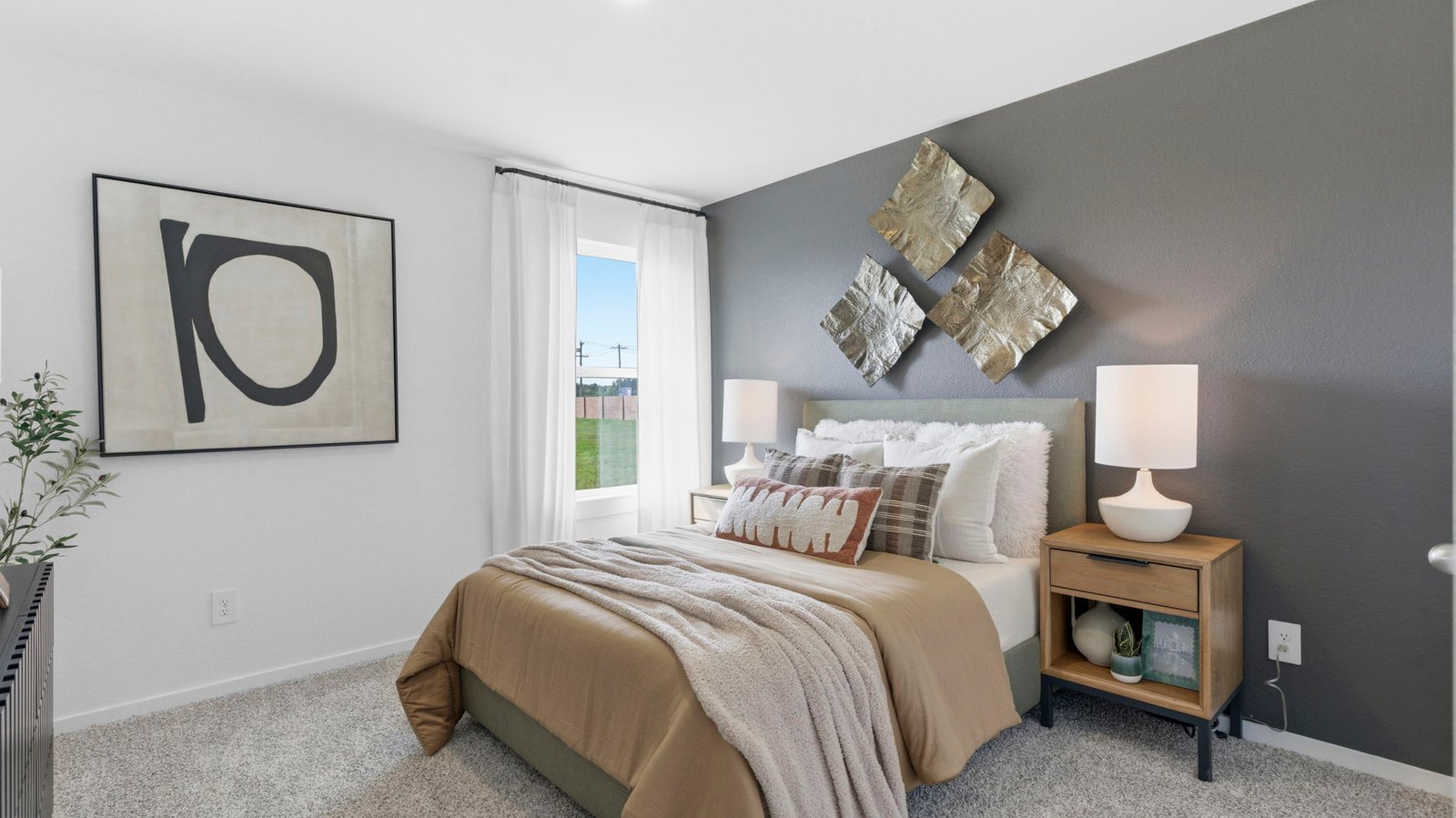 Comfortable guest bedroom featuring neutral-toned walls, carpeted flooring, and a separate closet.