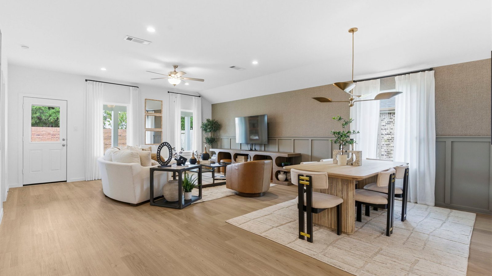 A well-organized living room that includes a kitchen and dining area, creating a warm and welcoming environment for gatherings.