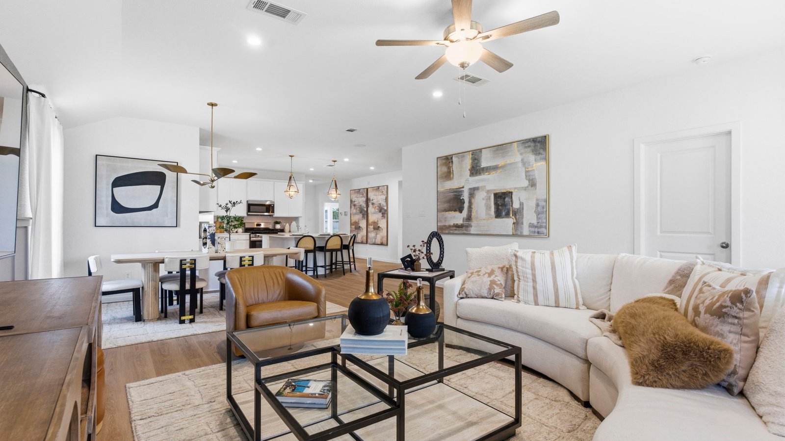 A well-organized living room that includes a kitchen and dining area, creating a warm and welcoming environment for gatherings.
