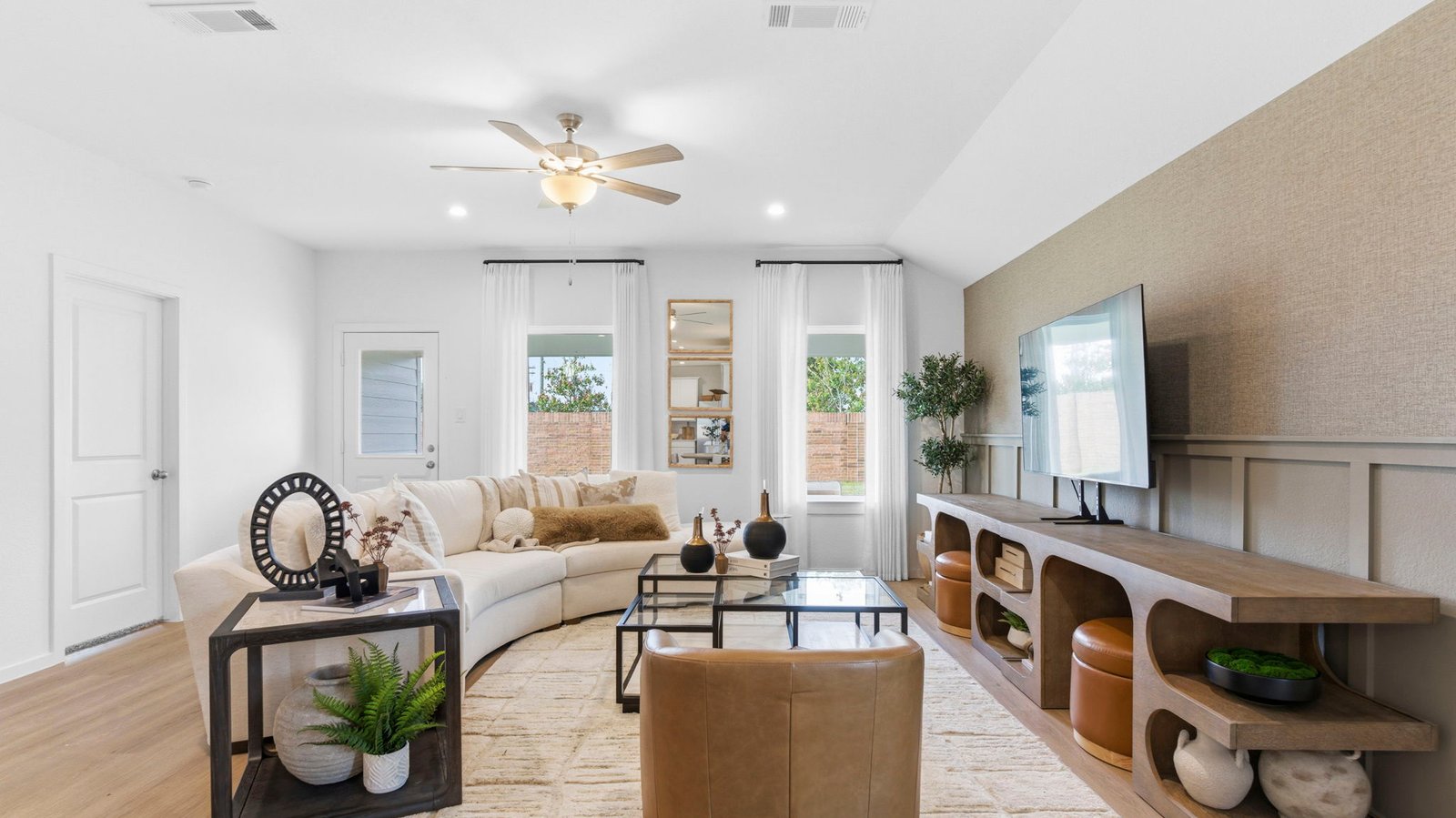 A well-organized living room that includes a kitchen and dining area, creating a warm and welcoming environment for gatherings.
