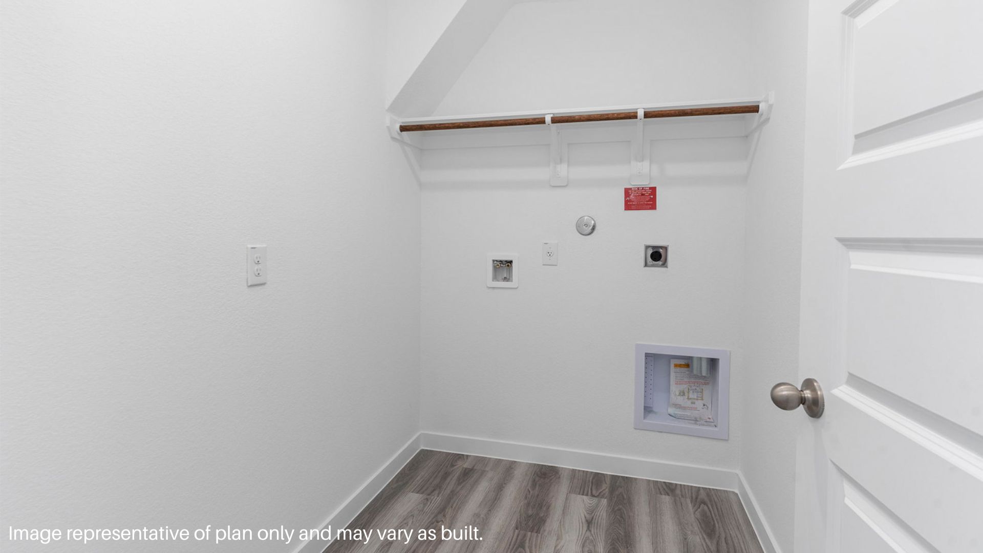Utility room with vinyl flooring and overhead storage space.