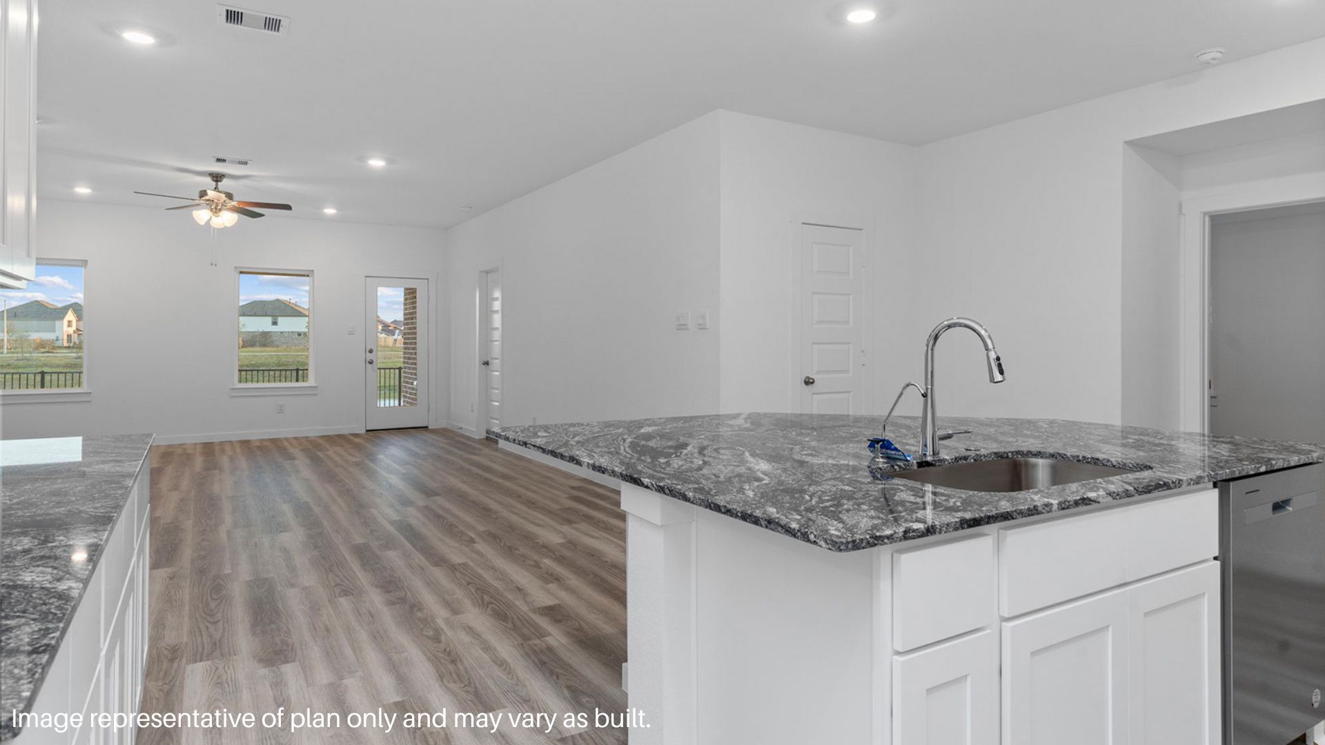 Spacious family room with vinyl flooring and bright windows.