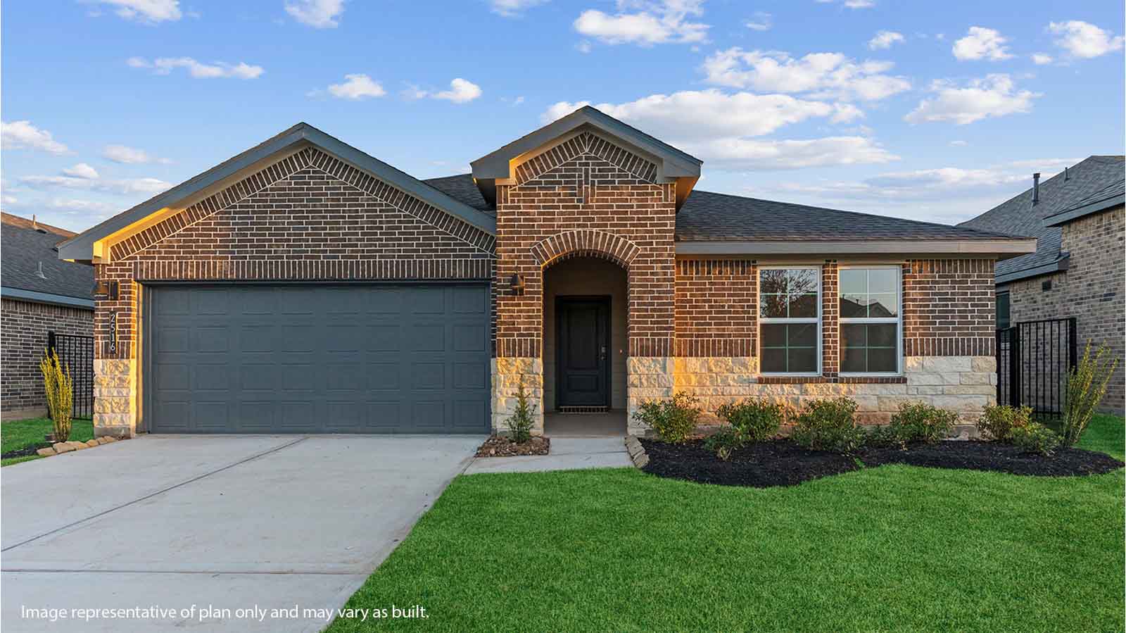 Single story brick home with a two car garage