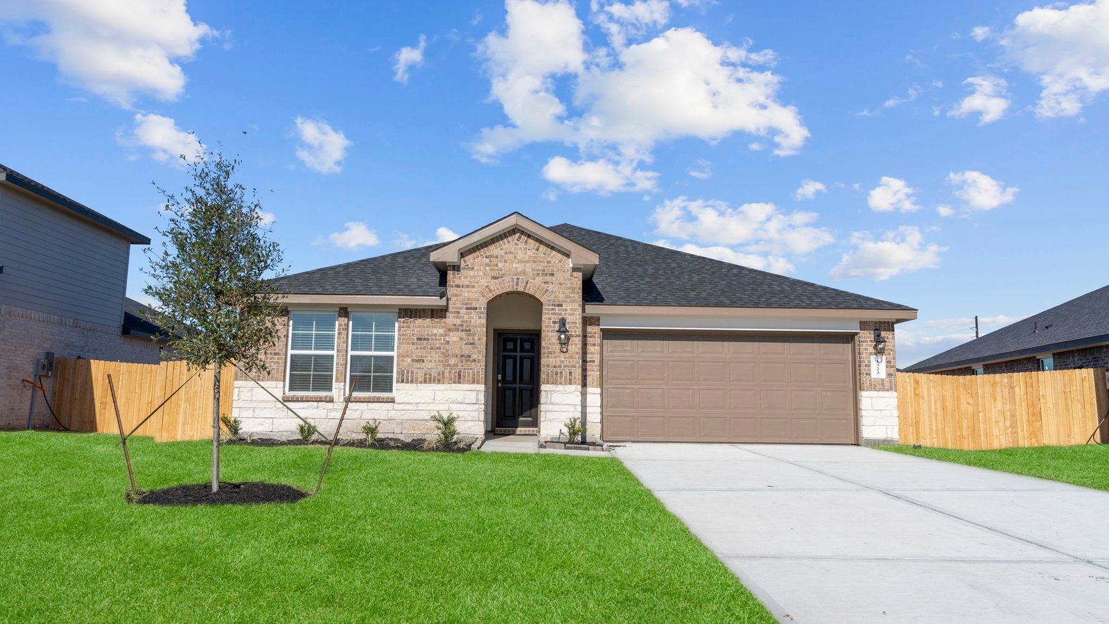single story brick home with a two car garage