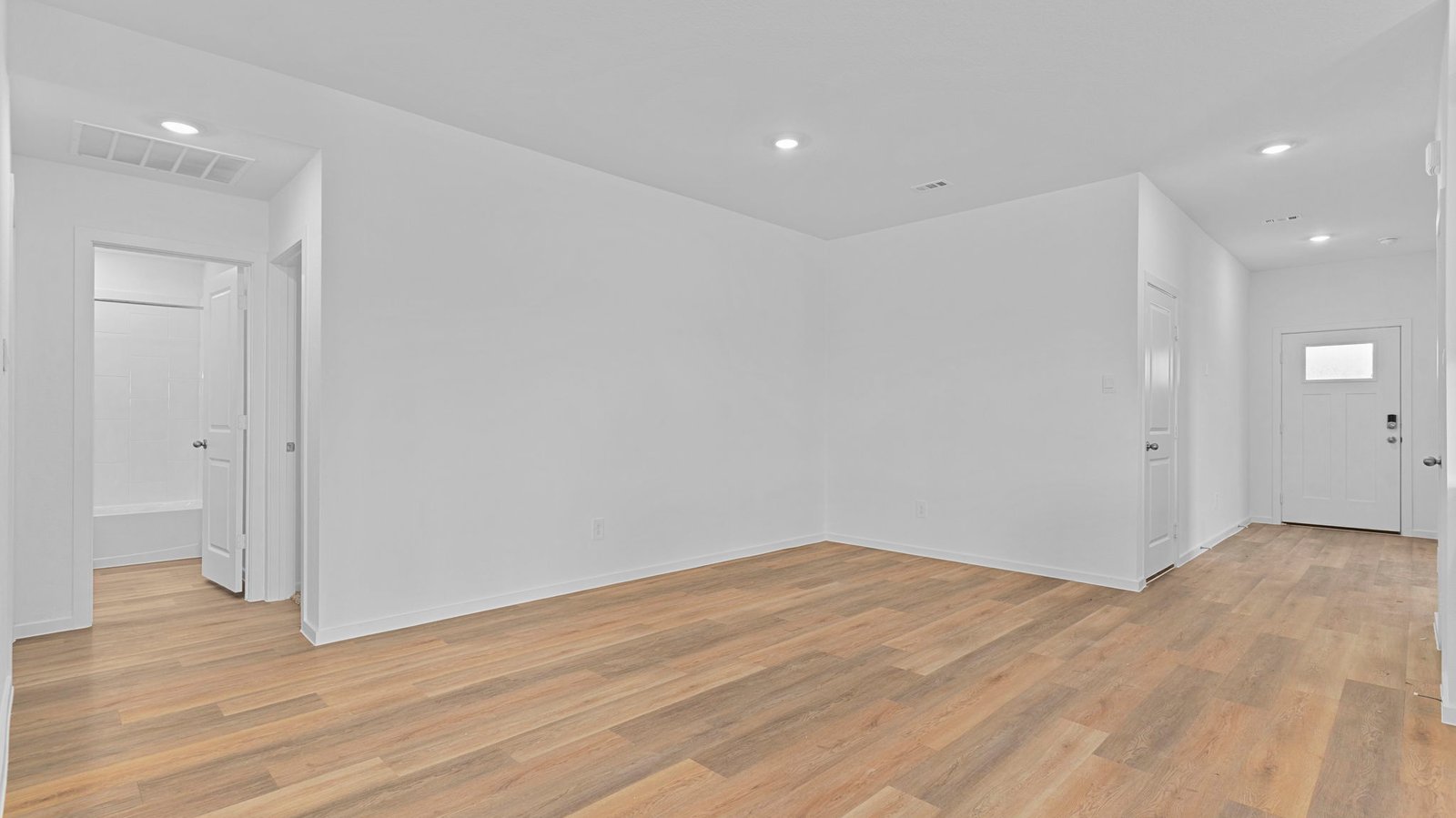 Spacious open concept dining area with vinyl wood flooring and access to the living and kitchen areas