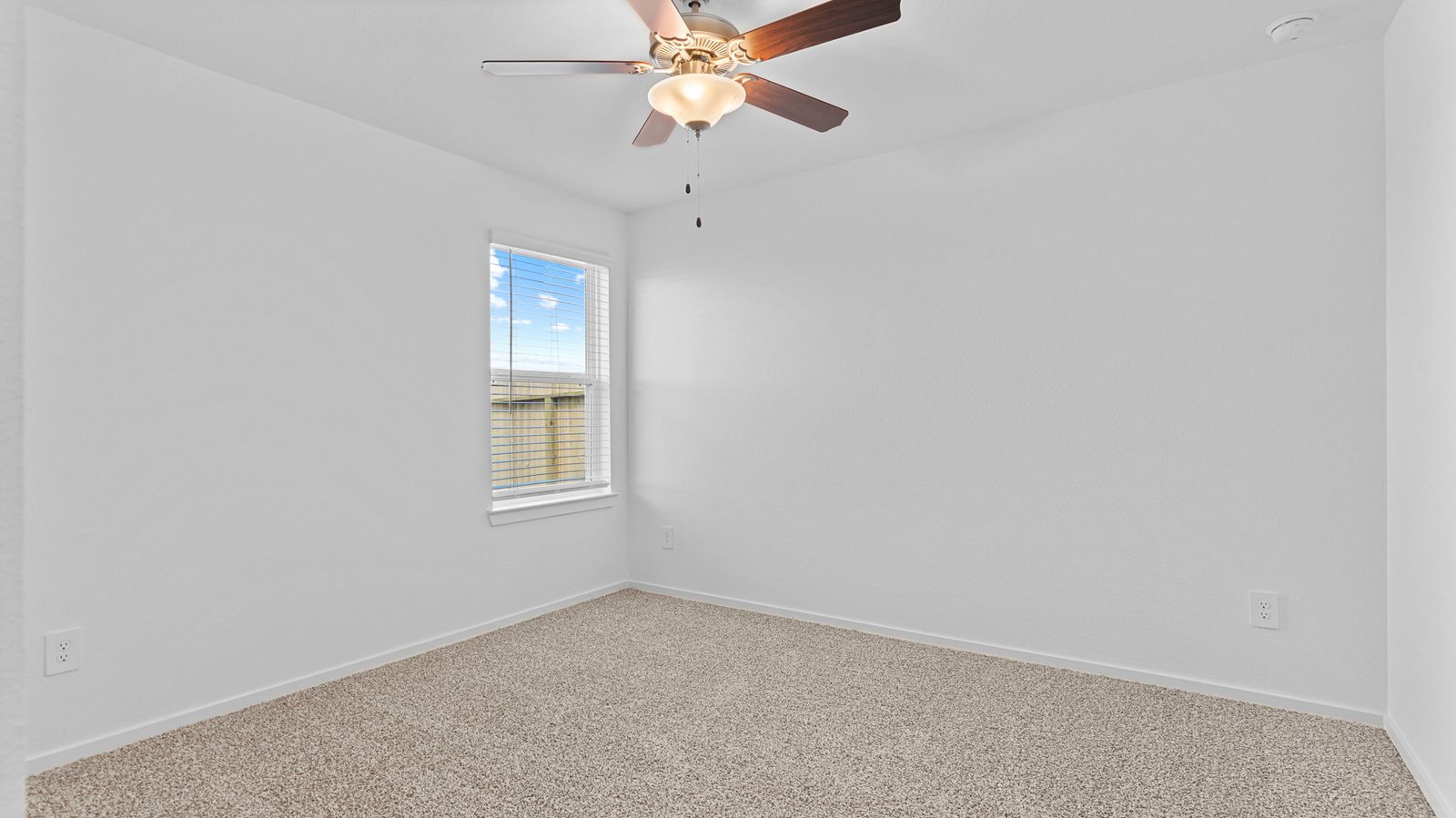 Comfortable guest bedroom featuring neutral-toned walls, carpeted flooring, and a separate closet.