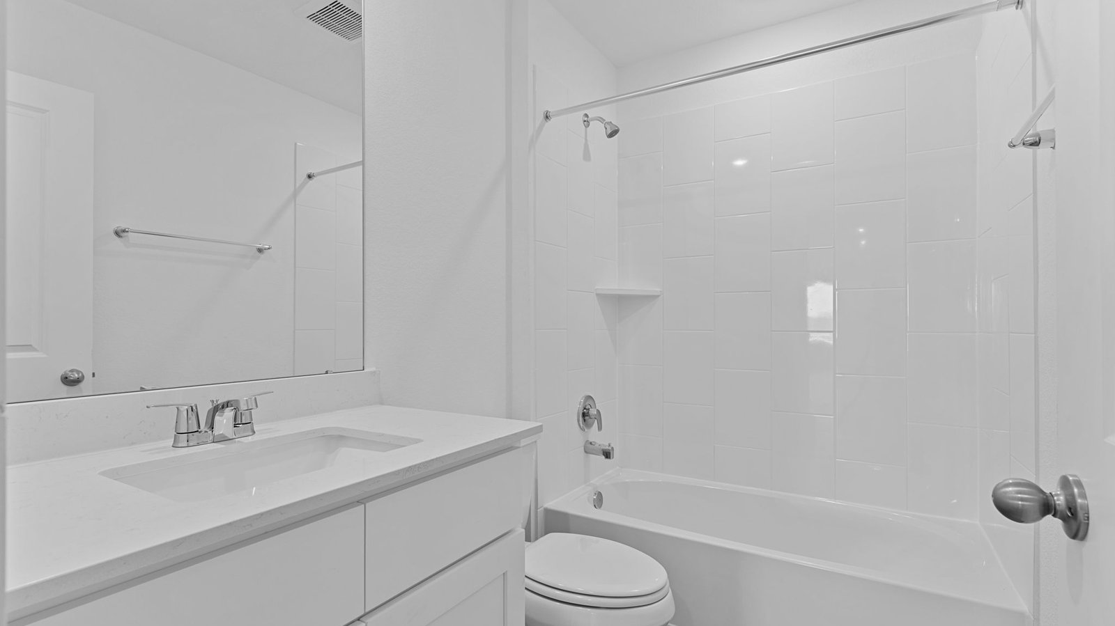 A well-designed bathroom equipped with quartz countertops, a standing tub, and a single vanity.