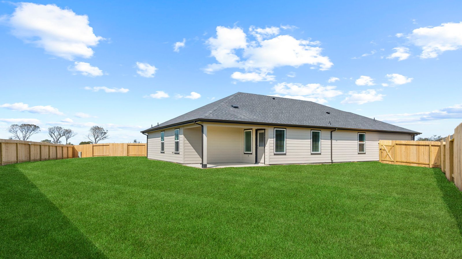 Large fenced-in backyard with a covered patio, perfect for outdoor entertaining.