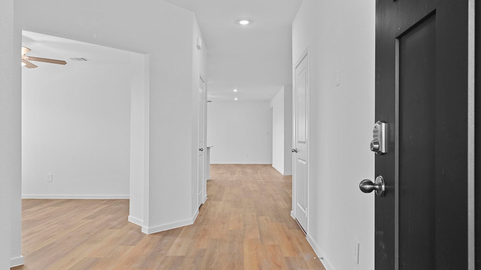 Entry hallway leading to living room and kitchen in the background.