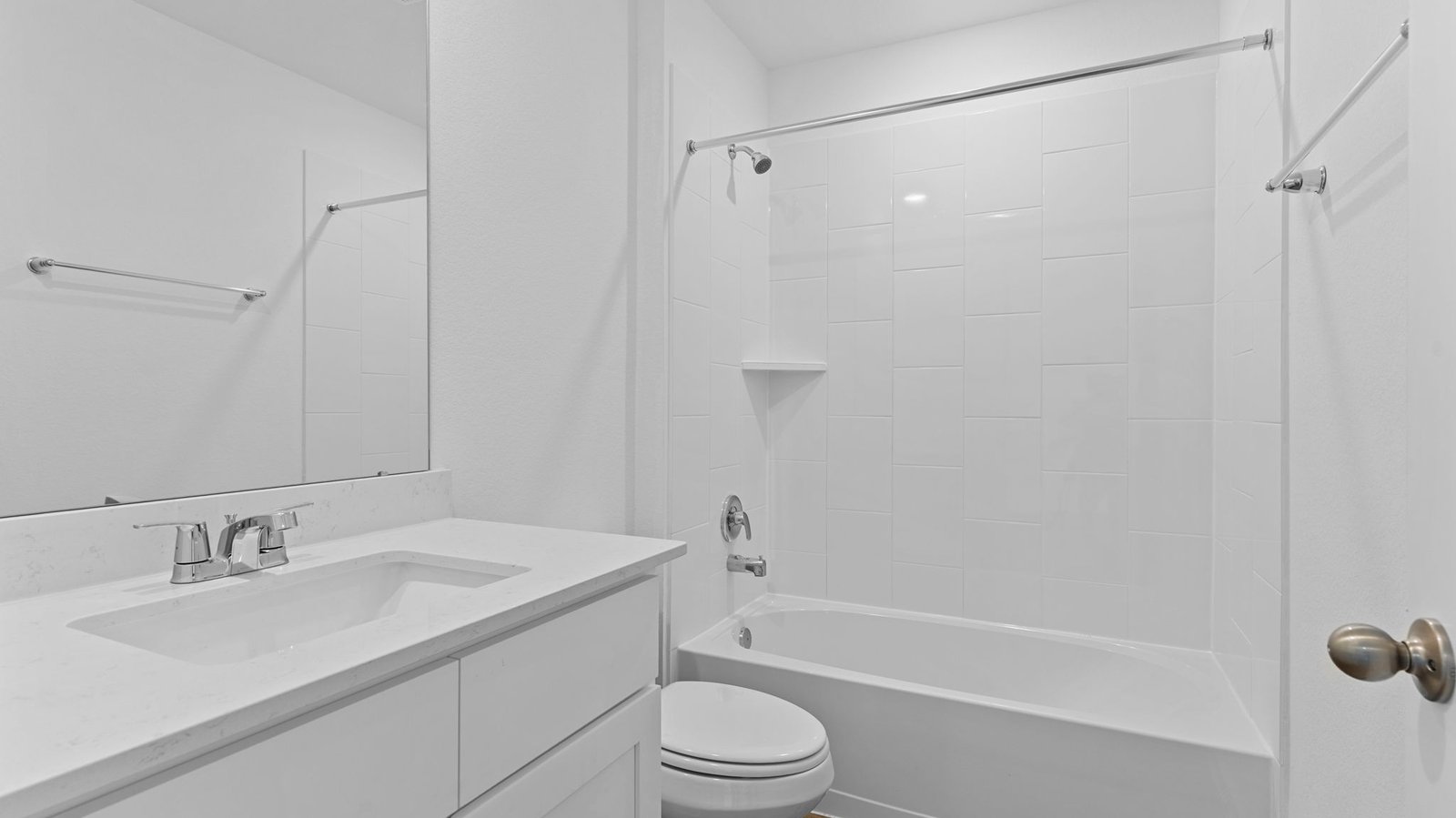 A well-designed bathroom equipped with quartz countertops, a standing tub, and a single vanity.