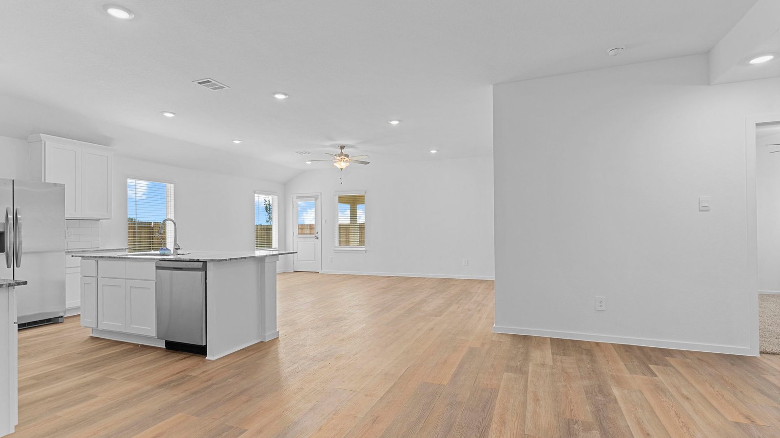 Spacious open concept dining area with vinyl wood flooring and access to the living and kitchen areas