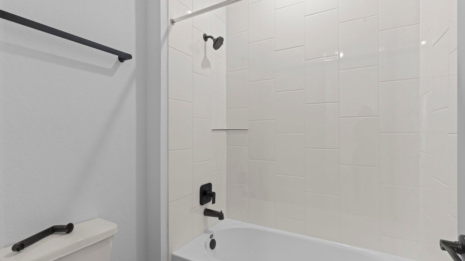 secondary bathroom with bathtub and shower combo