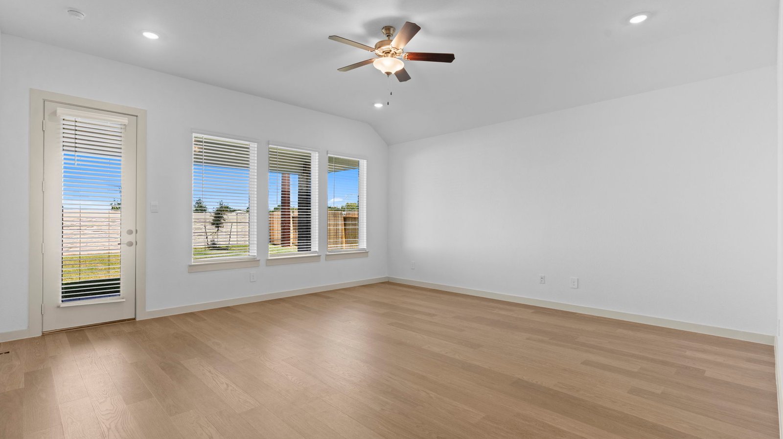 living room with 3 large windows and back patio door