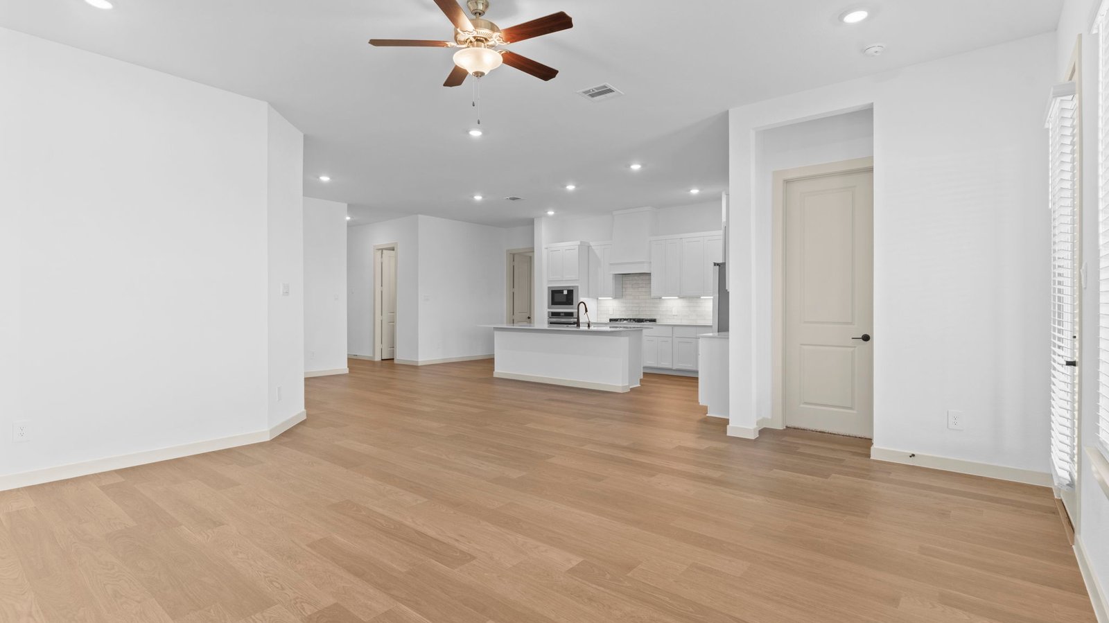 open concept living room with celling fan